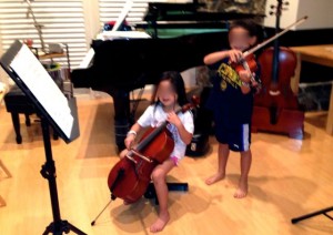1/10 cello, 1/4 violin full size cello in the background